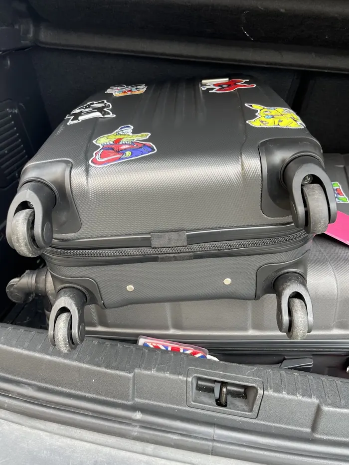 Repaired suitcases loaded into a car boot, ready to go back to their owner