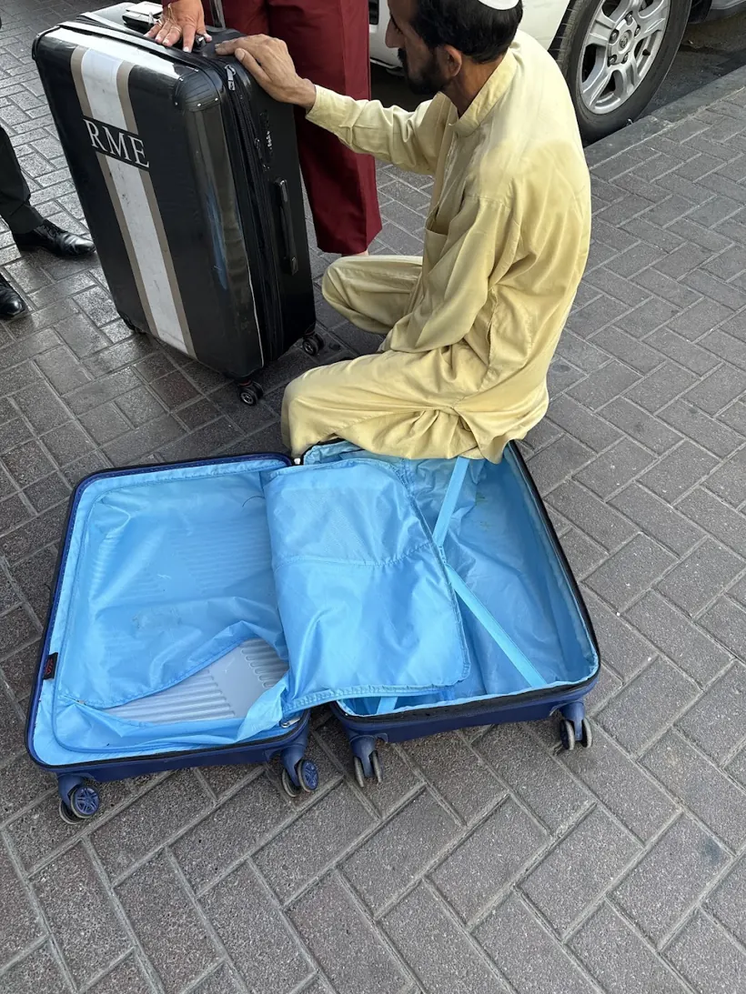 Our repairman on Al Satwa Road with a suitcase brought in for repair